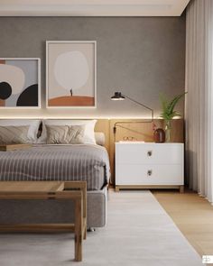 a bedroom with a bed, nightstands and two paintings on the wall above it