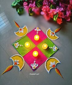 an artistically decorated diya with lit candles