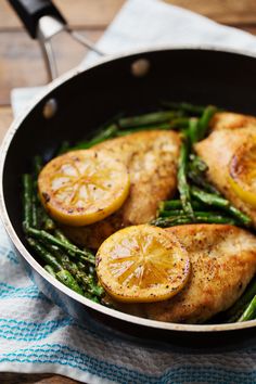 chicken, asparagus and lemon slices in a skillet