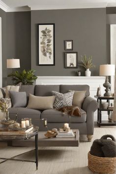 a living room filled with furniture and decor on top of a hard wood floored floor