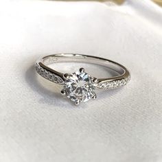 a white gold engagement ring with diamonds on it