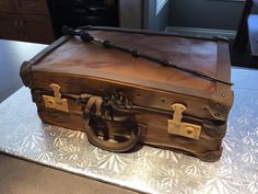 an old suitcase cake is sitting on a table