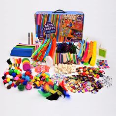 an assortment of arts and crafts supplies including pencils, crayons, pom poms