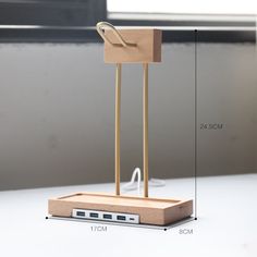 a wooden desk lamp with a usb port attached to it and measurements for the base