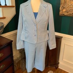 St, John Blue Seersucker Stripped Bermuda Shorts Suit With Blazer And Solid Blue Tank Top. Wow This Is Amazing And So Unique. New Suit - Never Worn - Tags Were Removed Gold Signature Medallions That Are Engraved St. John On Each Piece Shorts - Size 6 - $795 Jacket - Size 10 - $1,295 Top - Medium - $295 It’s Just Gorgeous!!!!! Over 80% Discount Spring Pinstripe Suits For Work, Spring Pinstripe Suits For Office, Spring Pinstripe Office Suits, Spring Office Pinstripe Suits, Spring Pinstripe Long Sleeve Suits, Pinstripe Long Sleeve Suit For Spring, Spring Pinstripe Suit With Long Sleeves, Fitted Pinstripe Blazer For Spring, Spring Fitted Pinstripe Blazer