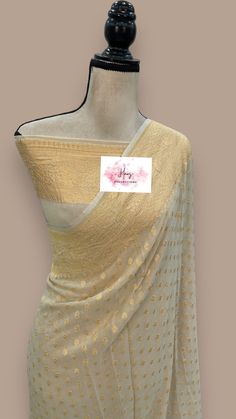 This pure georgette banarasi saree is certified by Silk mark, ensuring its authenticity. Made from high-quality materials, this saree is soft and comfortable to wear. With its intricate benarasi design, it adds a touch of elegance to any occasion. Elevate your style with this exquisite piece. fall & pico done Blouse: 36 to 40 Adjustable Size stitched blouse Designer Semi-stitched Georgette Saree, Designer Georgette Saree With Unstitched Blouse, Designer Georgette Saree With Dupatta, Designer Georgette Saree, Designer Georgette Blouse With Traditional Drape, Gold Georgette Blouse Piece With Zari Weaving, Designer Georgette Blouse Piece For Festivals, Designer Gold Georgette Saree, Gold Designer Saree In Traditional Drape