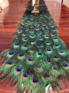 the peacock is standing on top of the table