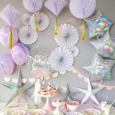 a table topped with lots of desserts and balloons