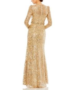 a woman in a gold sequinned gown with long sleeves and a high neckline