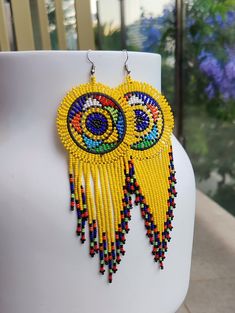 Kelis Africa Presents Kenyan Earrings, Intricately Handwoven Kenyan Massai Earrings.  A great addition to any earring lovers collection. The earrings are created from seed beads carefully woven together with wire threads. Making them the perfect accessories to make you stand out.  There are variety of colours for each season enabling you to wear them at anything of the year and for various occasions.  There are the perfect gift for that outstanding lady. 14cm Long Yellow Single Dangle Earring, Single Yellow Dangle Earring, Yellow Beaded Earrings For Pierced Ears As Gift, Yellow Round Beaded Earrings For Gifts, Yellow Dangle Plug Earrings As Gift, Yellow Dangle Jewelry With Matching Earrings, Bohemian Yellow Round Earrings, Yellow Bohemian Round Earrings, Handmade Yellow Dangle Plug Earrings