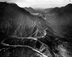 an aerial view of mountains and roads in black and white, taken from the air