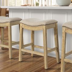 three stools in front of a kitchen island