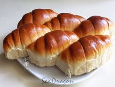 a white plate topped with rolls on top of a table