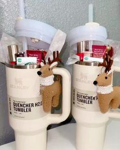 two coffee mugs with reindeer decorations on them