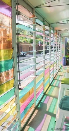 an outdoor cafe with colorful blinds on the wall