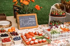 an assortment of fresh fruits and vegetables on display at a farmers'market table with a sign that says produce