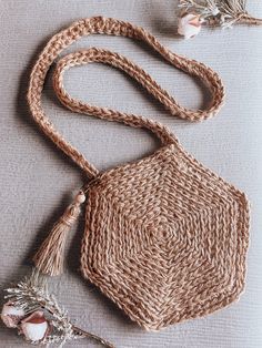 a woven bag with tassels on it