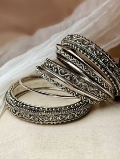 Add a touch of boho chic to your outfit with our Abirami Oxidised Bangle Set. This set includes 9 beautifully designed kadas and bangles in 4 unique patterns, giving you endless options to mix and match. Set of nine. Unique Oxidised Earrings, Oxidised Jewellery Bangles, Unique Jewellery Designs, Oxidised Bangles Set, Oxidised Jewellery Indian Outfit, Oxodise Jewellery Bangles, Oxidised Jewellery Indian, Traditional Oxidized Bangle For Wedding, Garba Bangles