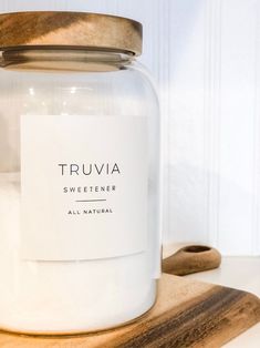 a glass jar sitting on top of a wooden cutting board