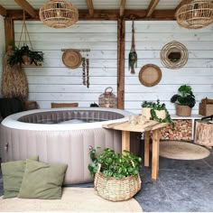 a large hot tub sitting in the middle of a room next to a wooden table