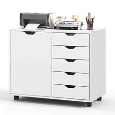 a white cabinet with drawers and printer on top of it, next to other office supplies