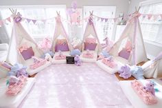 a pink and white bedroom with teddy bears on the bedspread, pillows and decorations