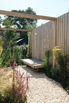 a wooden bench sitting in the middle of a garden