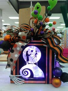 a decorated box with an image of a man and woman in the center surrounded by halloween decorations