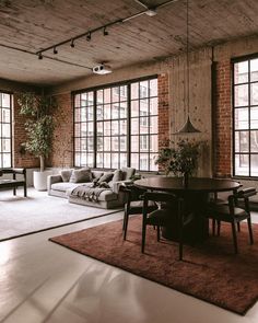 a living room filled with furniture and large windows