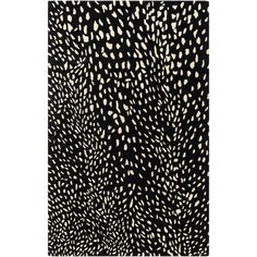 a black and white rug with lots of spots on it