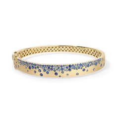 Discover the brilliance of our Scattered Gemstone Bangle and let your style shine. Whether you're dressing up for a special occasion or adding a touch of sophistication to your everyday look, this bangle is the perfect accessory to express your unique style and radiant personality. Available in 14K Yellow Gold Fits a size 17cm wrist Blue Sapphire weight = 2.61 carats Elegant Blue Diamond Bangle, Sapphire Bangle, Gemstone Bangle, Diamond Cocktail Rings, Sapphire Bracelet, Band Bracelet, Bracelet Collection, Blue Bracelet, Gold Jewelry Fashion