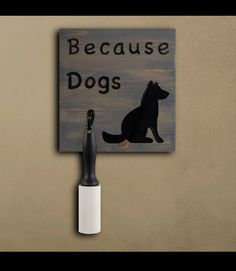 a sign that says because dogs is on the wall next to a toothbrush holder