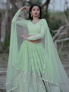 This exquisite ensemble exudes elegance and charm with its pastel green color and intricate detailing. Crafted from high-quality georgette fabric, the lehenga is adorned with zari embroidered and heavy sequin work, making it a perfect choice for weddings, receptions, engagements, and other special occasions.
The semi-stitched design allows for customization up to 42 inches, ensuring a perfect fit for every body type. The matching blouse, also made from georgette material with zari and sequin wor Pastel Green Color, Engagement Gown, Lehenga Crop Top, Georgette Material, Lehenga Choli Wedding, Floral Lehenga, Party Wear Lehenga Choli, Reception Gown, Weddings Receptions