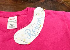 a pink t - shirt with the word peace written on it and a white banana hanging from its side