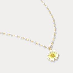 The Daisy Pearl Necklace is a perfect embodiment of elegance and playful charm. Crafted with a radiant enamel daisy pendant, the daisy flower necklace features delicate pearl accents on a gold-plated chain, creating a timeless blend of nature and sophistication. The daisy, with its luminous white petals and golden center, captures the essence of fresh beauty, while the pearls add a touch of classic grace. Ideal for those who adore  nature-inspired jewelry , this piece is both whimsical and versatile, making it perfect for daily wear or special occasions. DETAILS Plating: 18K Gold Materials:   18K Gold on Brass, Enamel, Artificial Pearl, Cubic Zirconia Measurements: Length: 18.50 "(41cm) + Extender: 3.54"(6cm) Pendant   Size : 1.34"*0.67"(1.5cm*1.7cm) Weight: 5.3 g Flower Shaped Pearl Charm Necklace For Gift, Flower Shaped Pearl Charm Necklace Gift, Flower Shaped Pearl Charm Necklace As Gift, Delicate Floral Pearl Necklace, Gift Pearl Necklace With Flower Charm, Dainty Flower-shaped Jewelry With Pearl Chain, Elegant Daisy Flower Charm Jewelry, Spring White Pearl Charm Jewelry, Dainty Flower Shaped Pearl Charm Jewelry