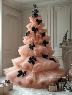 a pink christmas tree with black bows on it