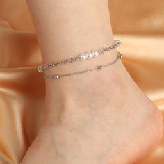 Accessorize your favorite skirts, shorts and dresses with this lovely pearl and silver-plated anklet. 9.25" L with 1.77" extender Lobster claw clasp Silver-plated copper / pearl Elegant Adjustable Metal Anklets, Elegant Summer Anklets, Elegant Pearl Chain Anklet For Party, Elegant Pearl Anklets For Party, Elegant Spring Anklets For Gift, Elegant Spring Anklets As Gifts, Elegant Spring Anklets For Gifts, Pearl Chain Anklet For Party, Elegant Anklets With Extender