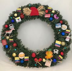 a christmas wreath with ornaments and decorations around it