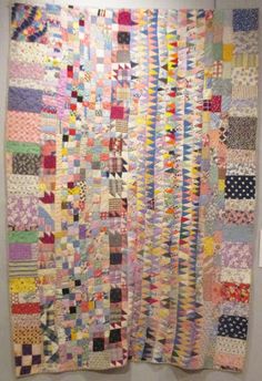 a very large quilt hanging on the wall