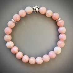 Soft Pink Opal Beaded Bracelet With A Stainless Steel Bead Handcrafted By Me Genuine Semi Precious Stones 8mm Pink Opal Often Referred To As The 'Stone Of Spiritual Awakening,' Pink Opal Helps With Self-Healing And Rejuvenates The Body And Mind. Pink Opal Is Also Considered To Be A Meaningful Gemstone For Someone To Hold If They Are Struggling With A Broken Heart 7.5” Approximately / Measure For Any Alterations Beaded Rose Quartz Bracelets With Round Beads, Rose Quartz Beaded Bracelets With Faceted Beads, Rose Quartz Faceted Beaded Bracelets, Handmade Rose Quartz Beaded Bracelets, Handmade Beaded Bracelets With Rose Quartz, Beaded Rose Quartz Crystal Bracelet, Halloween Charm Bracelet, Pyrite Bracelet, Pearl Bracelet Wedding