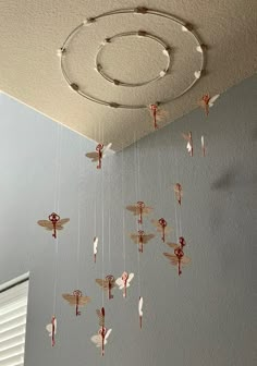 an image of a mobile that is hanging from the ceiling with dragonflies on it