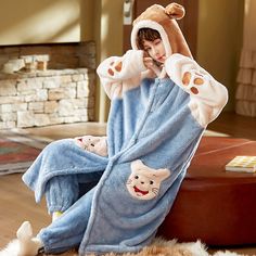 Prepare to stay cozy and kawaii all winter long with our Hooded Robe Winter Pajamas. These delightful pajama sets are designed to keep you warm while embracing your love for all things cute. With several charming styles to choose from, you can cuddle up in comfort and cuteness. Here's why you'll adore our Hooded Robe Winter Pajamas: Key Features: Superior Comfort: Made from high-quality materials, our pajamas offer supreme comfort. The soft and plush fabric feels gentle against your skin, making Cozy Hooded Super Soft Sleepwear, Blue Hooded Sleepwear For Pajama Party, Cozy Winter Onesie For Sleep, Playful Winter Onesie For Bedtime, Winter Kawaii Long Sleeve Onesie, Blue Hooded Sleepwear For Sleepover, Hooded Winter Loungewear, Cute Blue Winter Sleepwear, Hooded Winter Sleepwear For Lounging