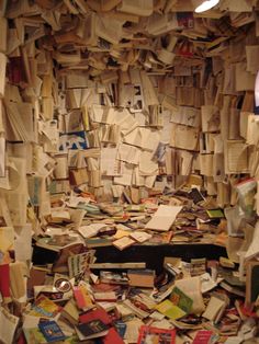 a room filled with lots of books and papers