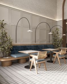 an empty restaurant with wooden tables and blue benches, potted plants on either side