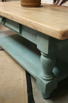 a wooden table with a potted plant sitting on it's top and bottom