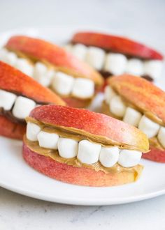 apple slices with marshmallows on them are arranged in the shape of teeth