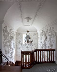 a chandelier hanging from the ceiling in a room with wallpapered walls