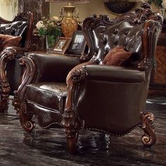 two brown leather chairs sitting next to each other