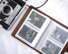 an open book with polaroid pictures and a camera