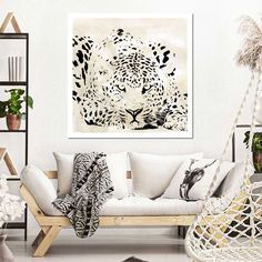 a living room with white furniture and a leopard painting on the wall above the couch